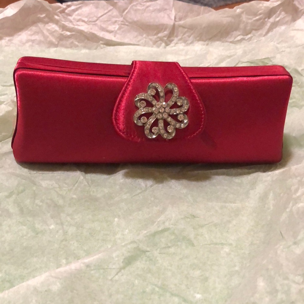 Target red satin like clutch with broach accent